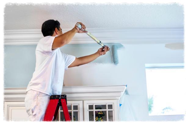 Man painting on a ladder